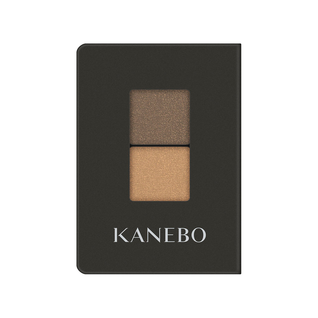 Kanebo Eye Color Duo featuring gold and bronze shades in a sleek black compact, perfect for warm and sophisticated eye makeup.