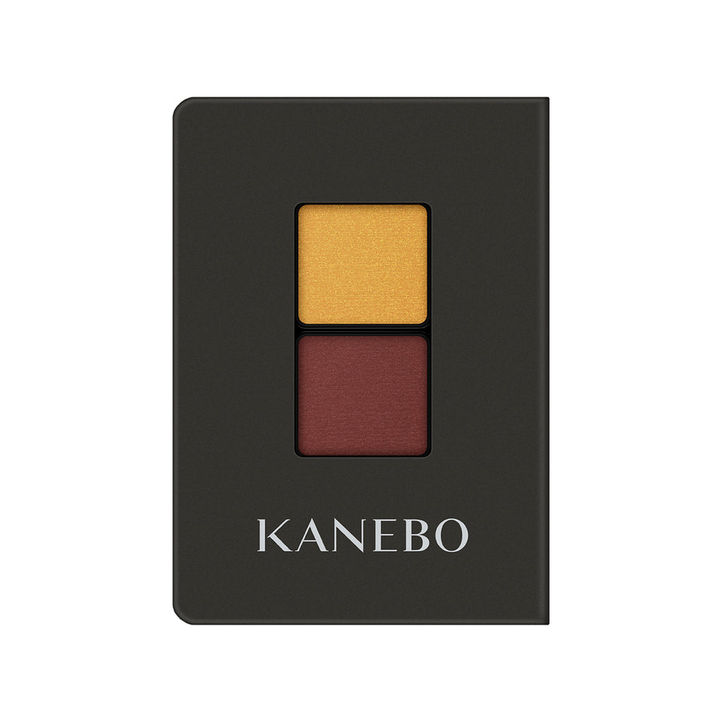 Kanebo Eye Color Duo featuring mustard yellow and deep red shades in a black compact, perfect for warm and dramatic eye makeup.