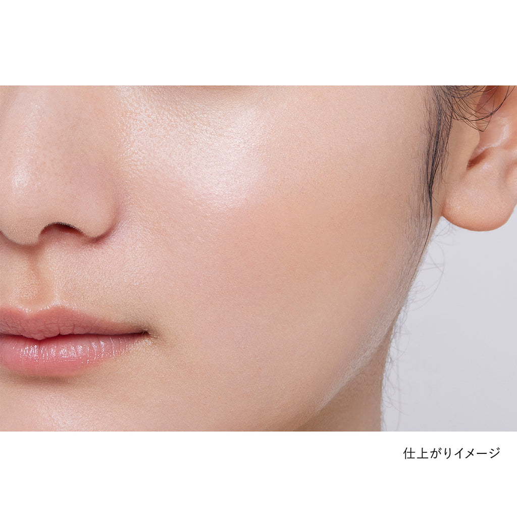 Close-up of a model's cheek showcasing the natural finish of Kanebo Mood Boosting Blush in orange and light yellow tones.