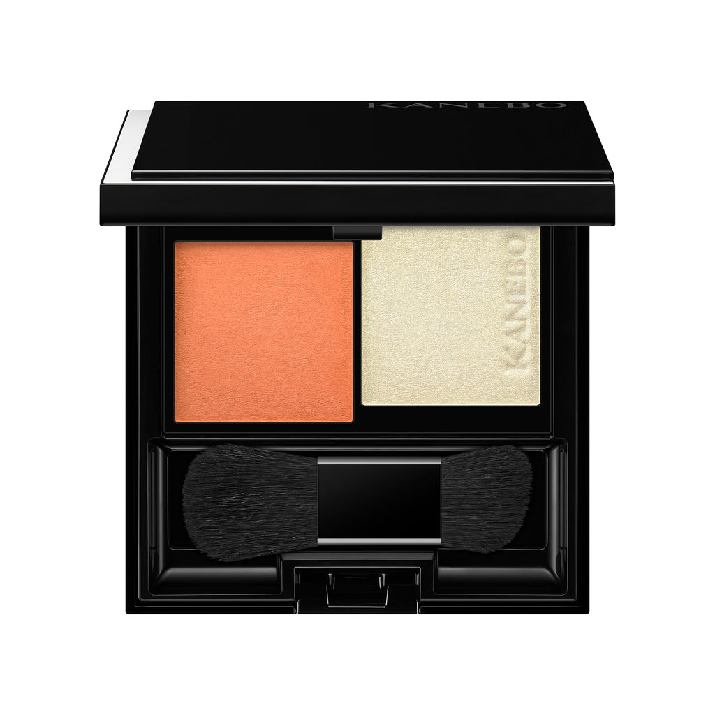 Kanebo Mood Boosting Blush in orange and light yellow shades with a compact design, dual brush, and sleek black case.