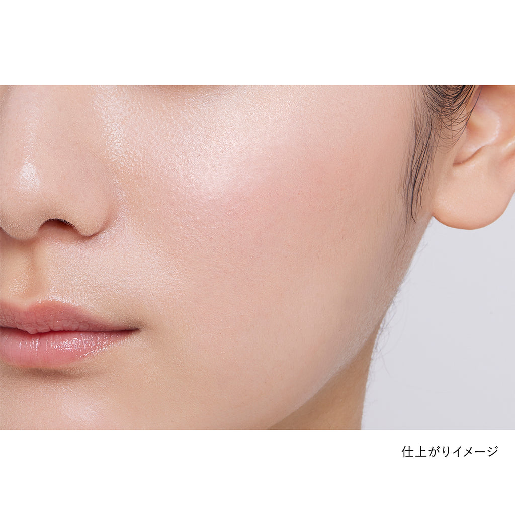 Close-up of a model's cheek showcasing the natural finish of Kanebo Mood Boosting Blush in coral and beige tones.