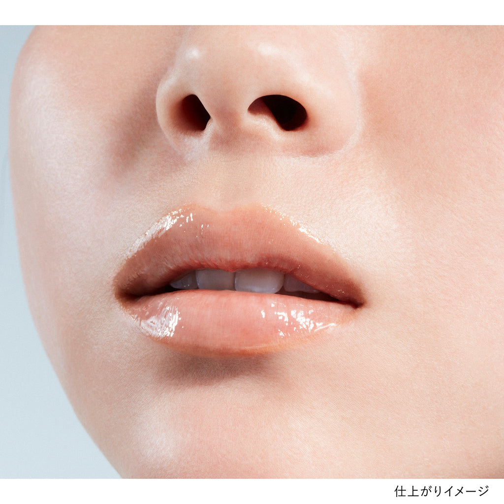 Close-up of lips wearing Kanebo Rouge Scrub Melting lipstick in a soft pink shade, showcasing a glossy and smooth finish.