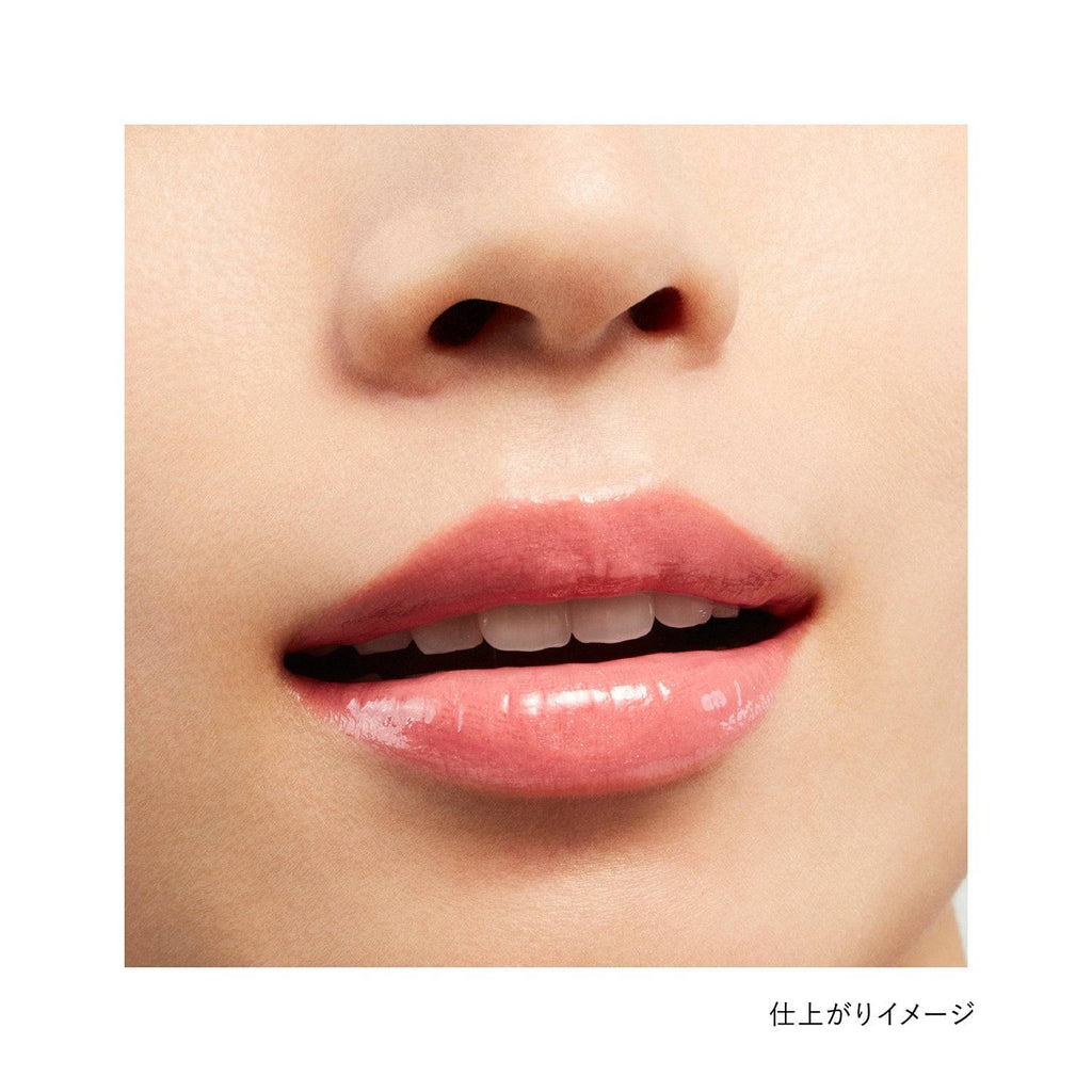Close-up of lips wearing Kanebo Rouge Star Vibrant lipstick in a pink shade, showcasing a glossy and vibrant finish.