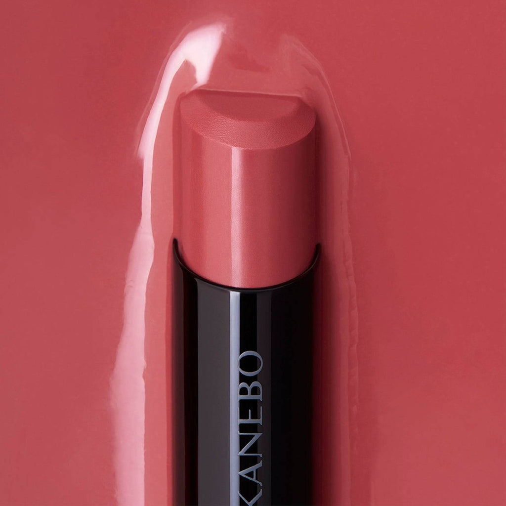 Kanebo Rouge Star Vibrant lipstick in a rose tone, highlighted against a matching background with a smooth, radiant finish.