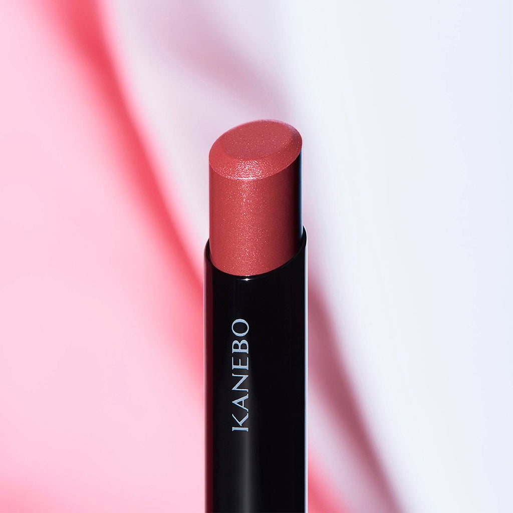 Kanebo Rouge Star Vibrant lipstick in a red tone, highlighted against a vibrant background with a smooth, radiant finish.