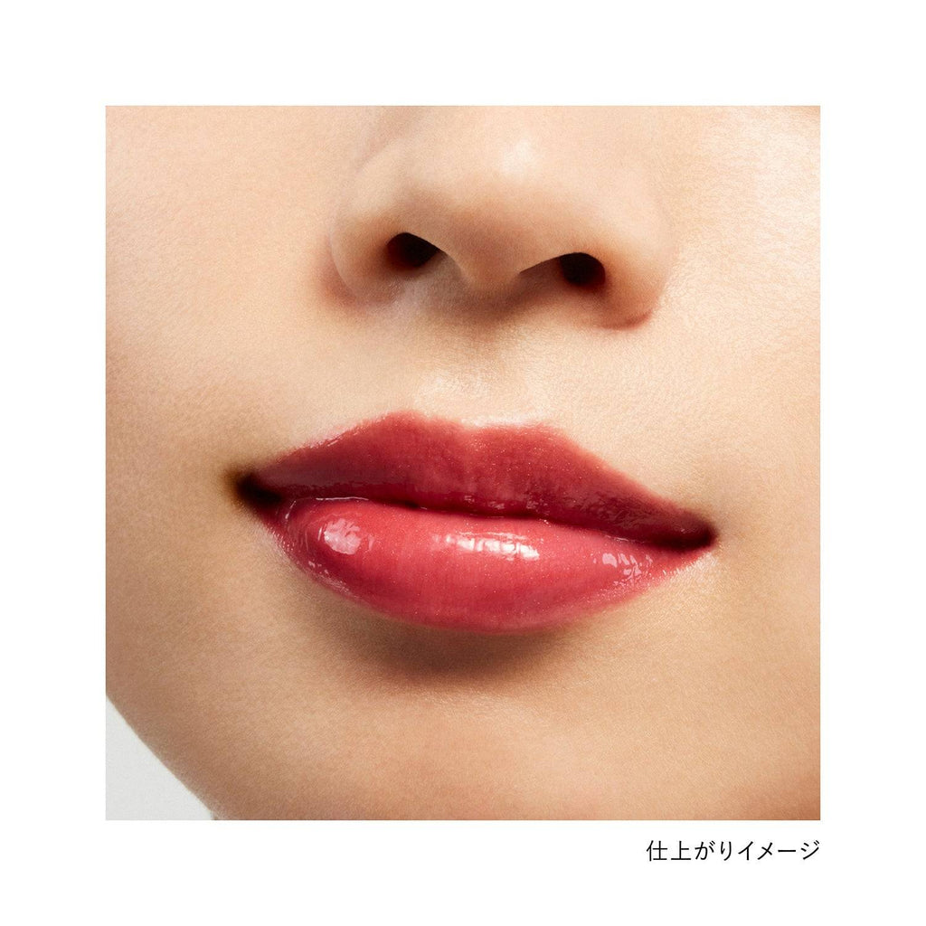 Close-up of lips wearing Kanebo Rouge Star Vibrant lipstick in a red shade, showcasing a glossy and bold finish.