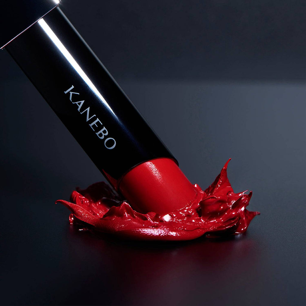 Kanebo Rouge Star Vibrant lipstick in a deep red tone, set against a dramatic background with a smooth, radiant finish.