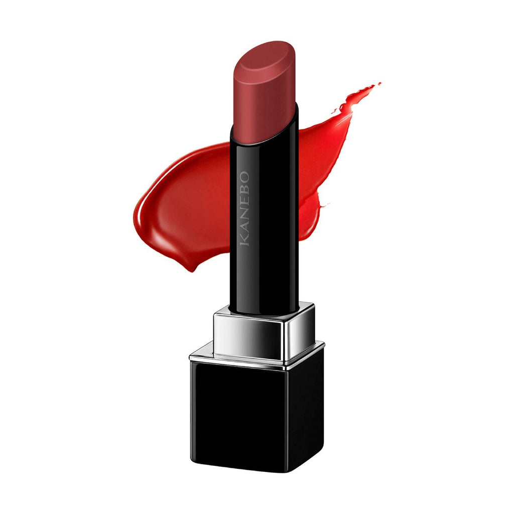 Kanebo Rouge Star Vibrant lipstick in a brownish-red shade with a creamy texture and glossy finish, paired with a color swatch.