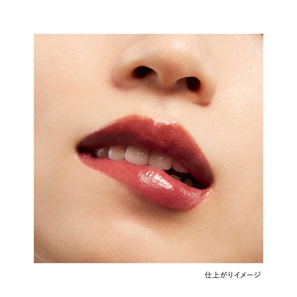 Close-up of lips wearing Kanebo Rouge Star Vibrant lipstick in a nude brown shade, showcasing a glossy and natural finish.