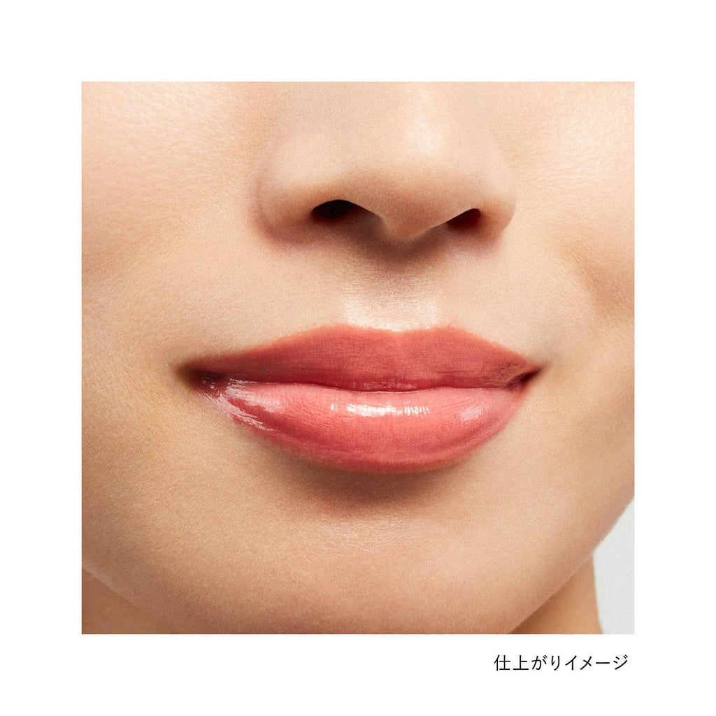 Lips wearing Kanebo Rouge Star Vibrant lipstick in a peachy nude shade, showcasing a glossy and natural finish.