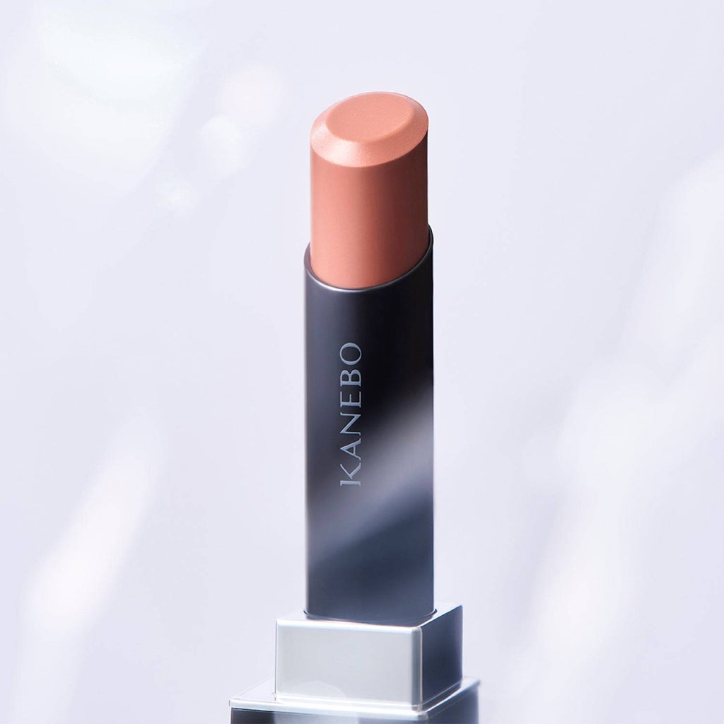 Kanebo Rouge Star Vibrant lipstick in a warm beige tone, set against a soft background with a smooth, radiant finish.