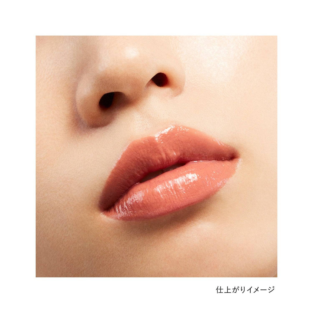 Close-up of lips wearing Kanebo Rouge Star Vibrant lipstick in a warm beige shade, showcasing a glossy and natural finish.