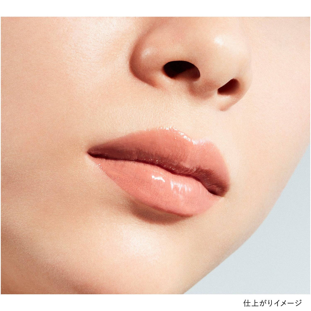 Close-up of lips wearing Kanebo Rouge Star Vibrant lipstick in a soft peach shade, showcasing a glossy and natural finish.