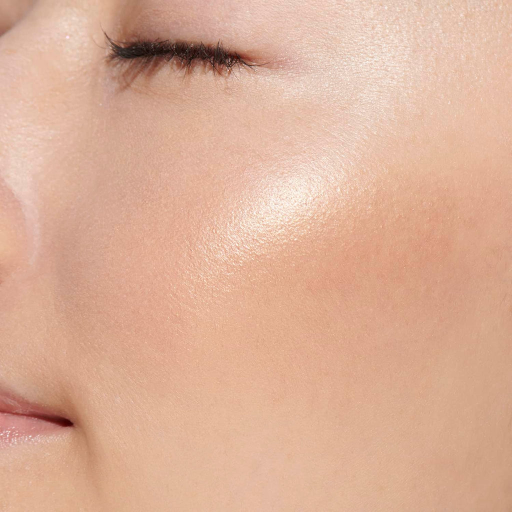 Close-up of a model's cheek showcasing the luminous beige shade of Lunasol Coloring Sheer Cheeks (Glow) for a natural glow.