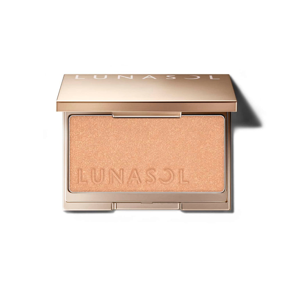 Lunasol Coloring Sheer Cheeks (Glow) in a golden compact with embossed logo, offering a luminous beige shade for a radiant finish.