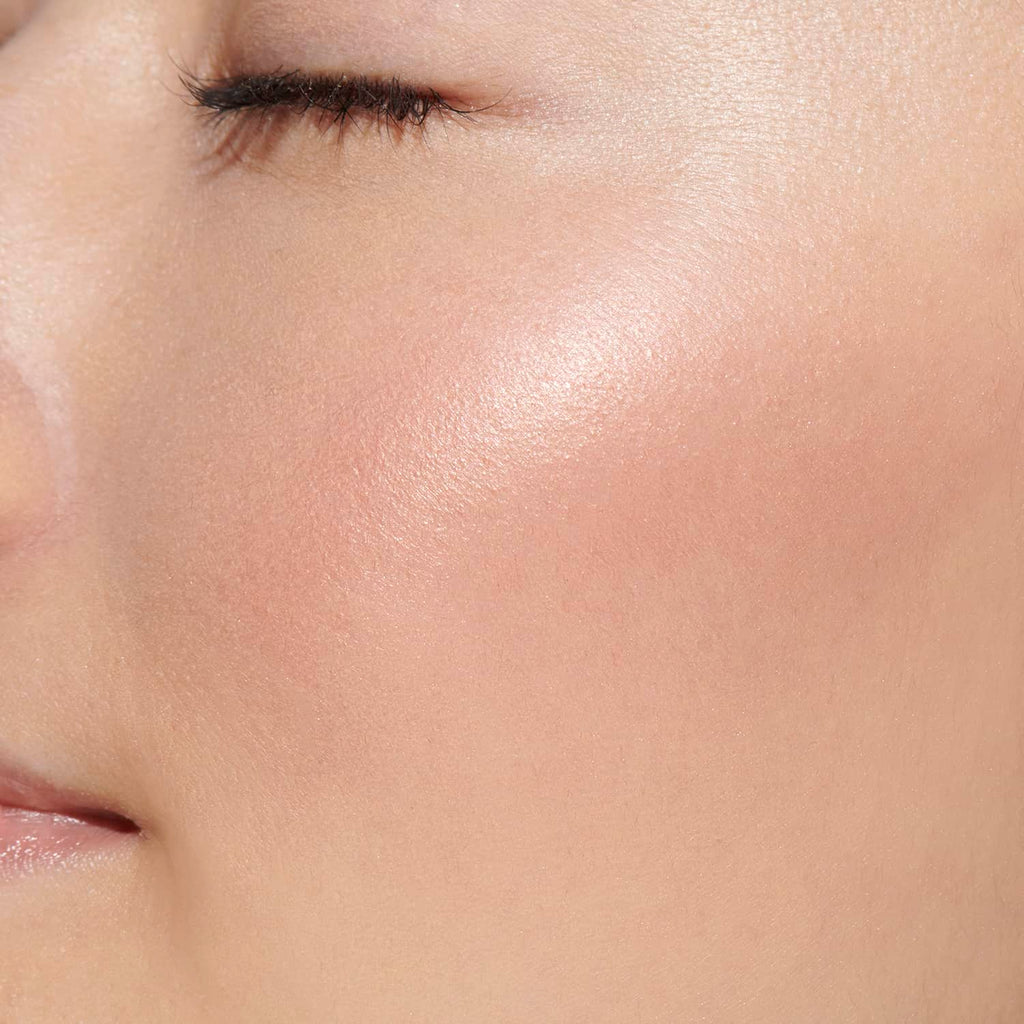 Close-up of a model's cheek showcasing the soft pink shade of Lunasol Coloring Sheer Cheeks (Glow) for a natural glow.