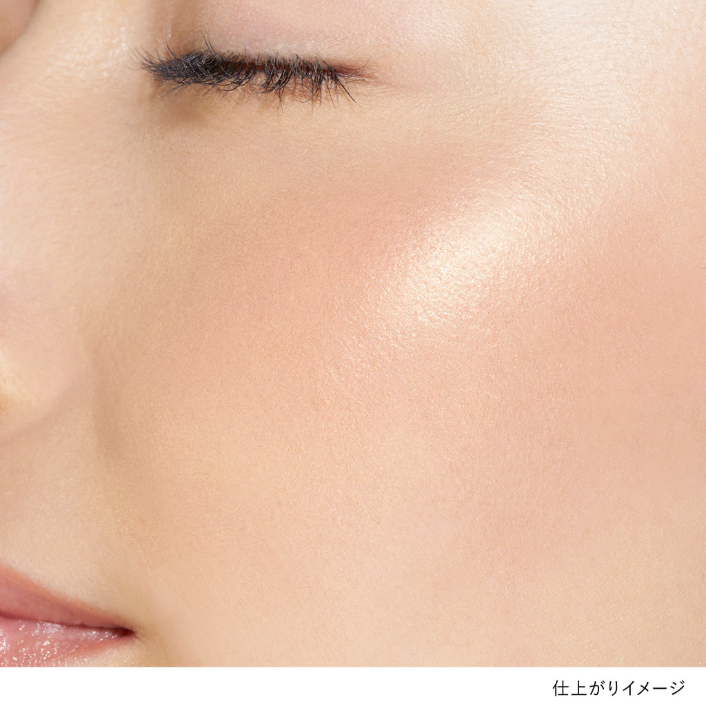 Close-up of a model's cheek showcasing the peachy pink shade of Lunasol Coloring Sheer Cheeks (Glow) for a natural glow.