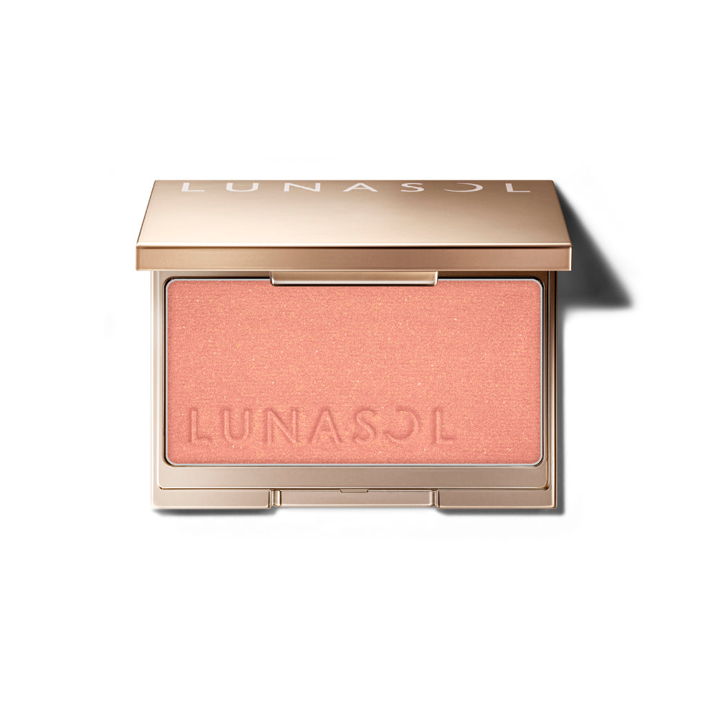 Lunasol Coloring Sheer Cheeks (Glow) in a golden compact with embossed logo, featuring a peachy pink shade for a radiant finish.