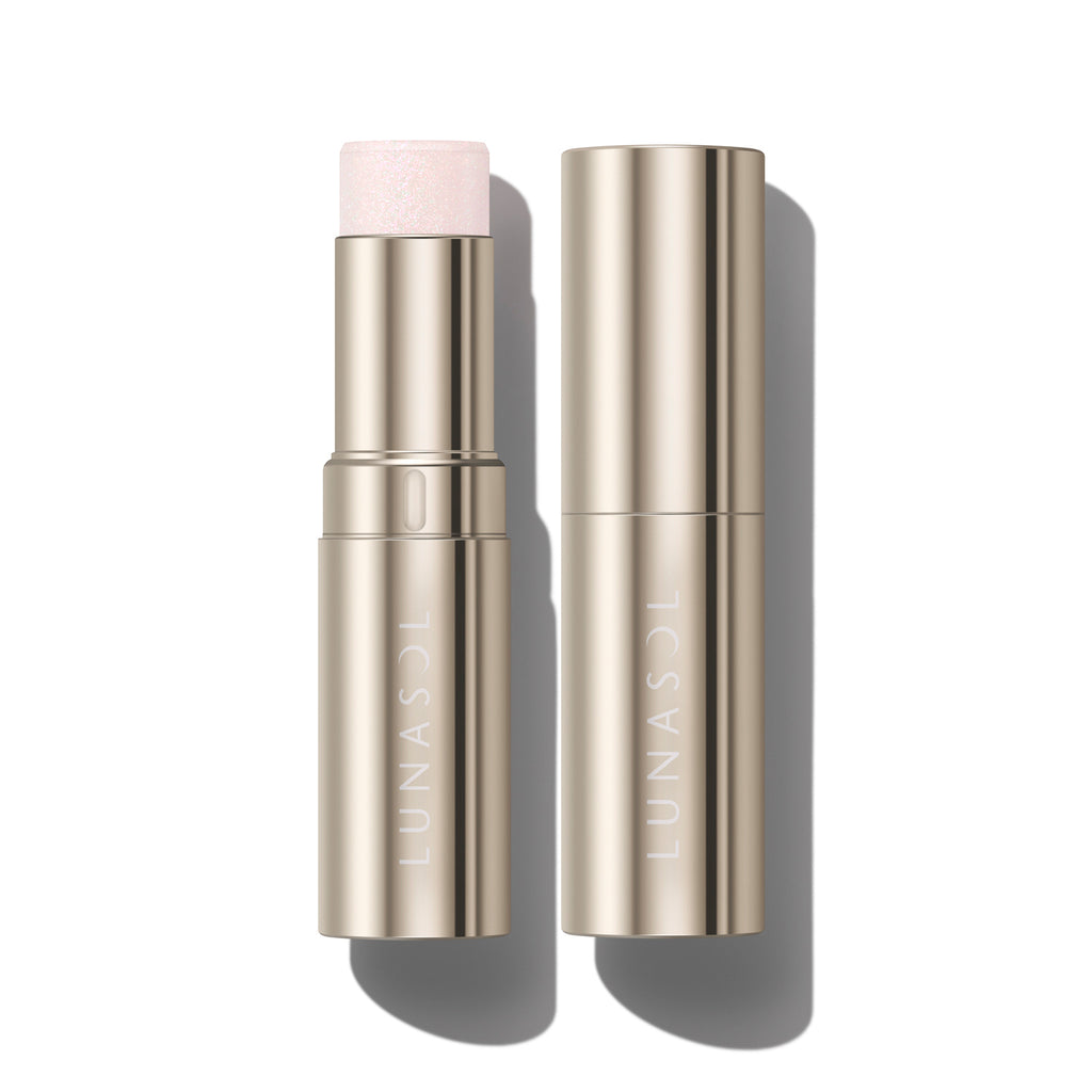 Lunasol Radiant Stick N highlighter in a gold tube, featuring a soft pink shade for a subtle shimmer effect.