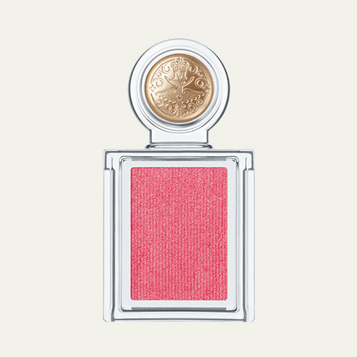 Pink blush compact with gold emblem on a light beige background