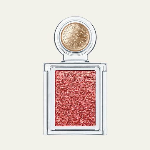 Makeup product with a gold cap and pink shade on a light background