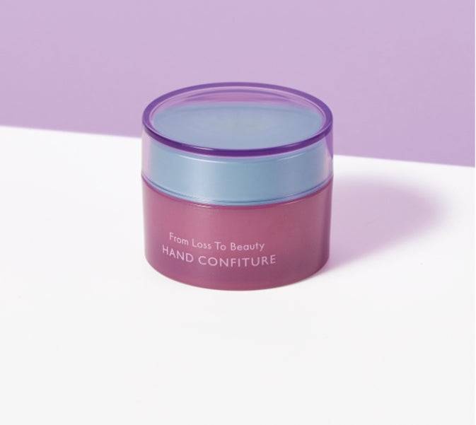 Pola From Lost to Beauty Hand Confiture 50g jar displayed against a pastel purple background, emphasizing its elegant design.