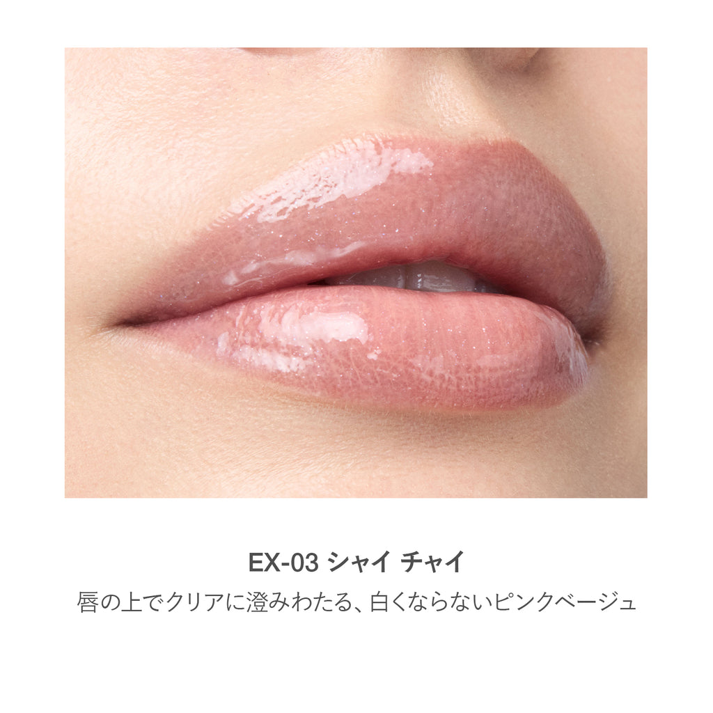 Close-up of lips wearing RMK Lip Luminizer 3.6g in shade EX-03, a translucent pink beige with a glossy and natural finish.