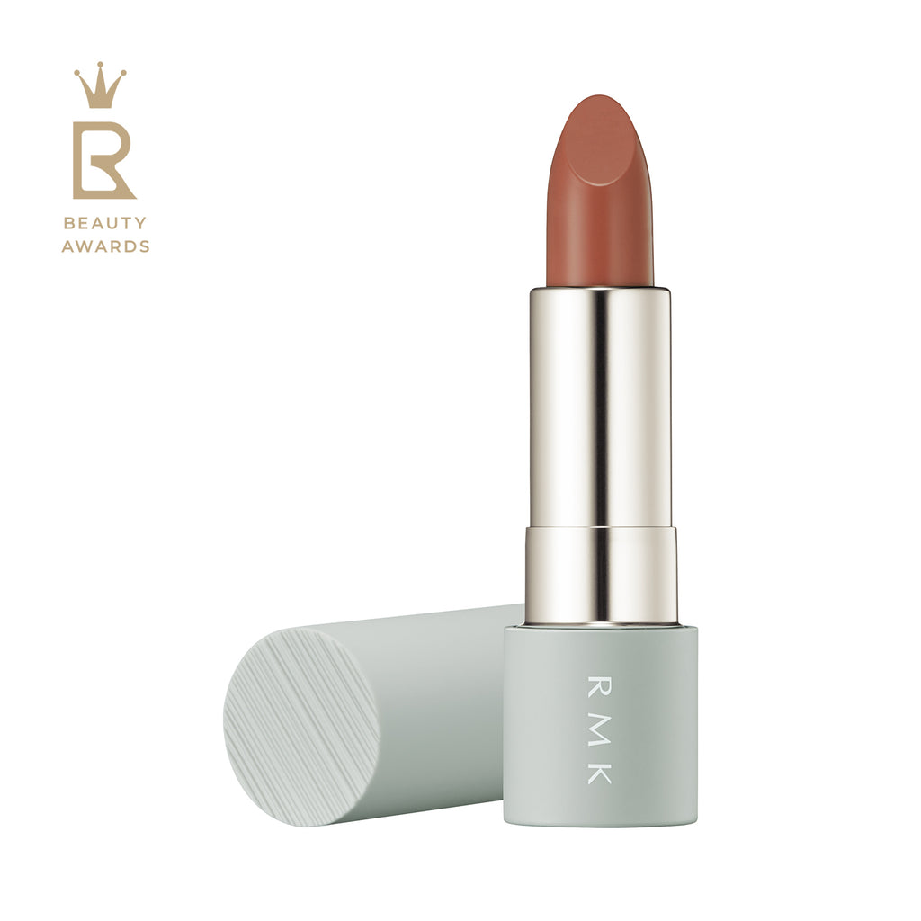 RMK The Matte Lip Color 4g in shade 01 Peach Fog, a soft nude beige lipstick with a matte finish, displayed in a sleek mint green tube.