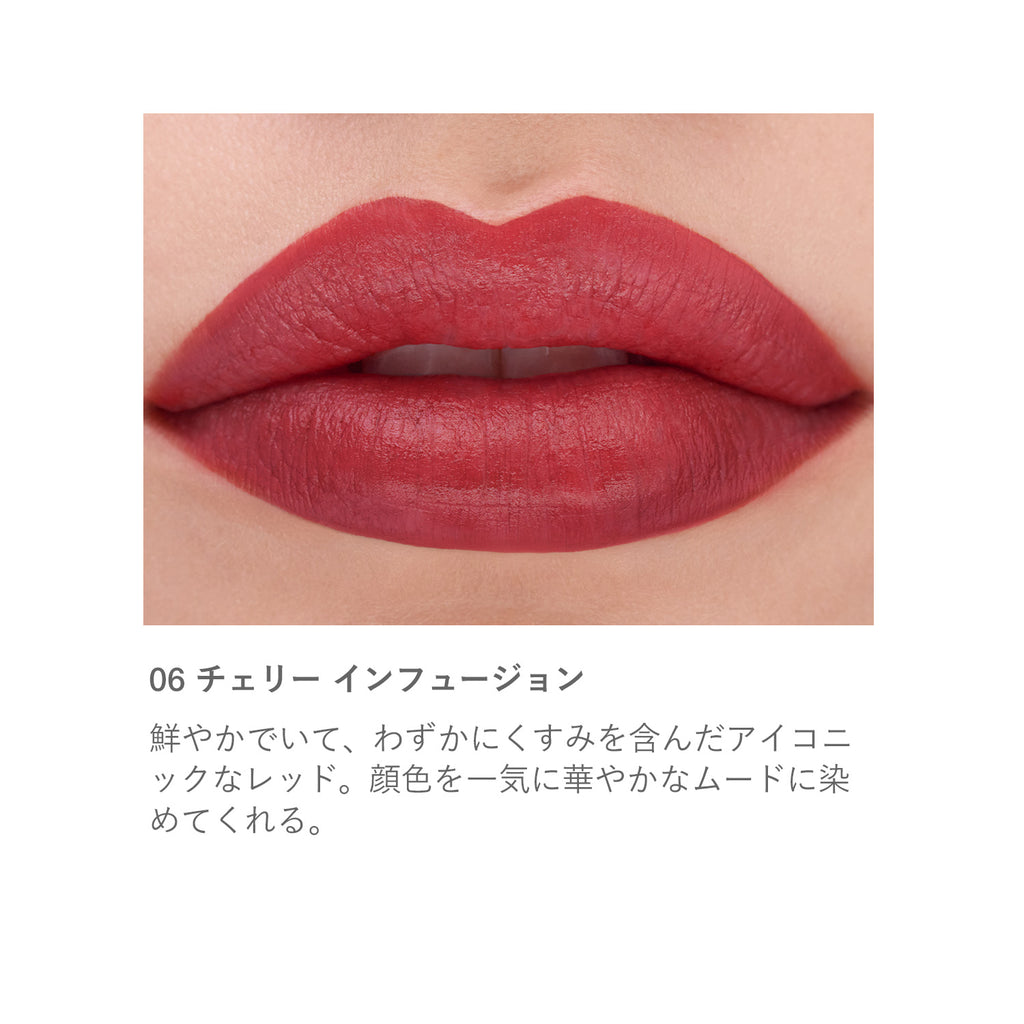 Close-up of lips wearing RMK The Matte Lip Color 4g in shade 06 Cherry Infusion, a bold red with a smooth matte finish.