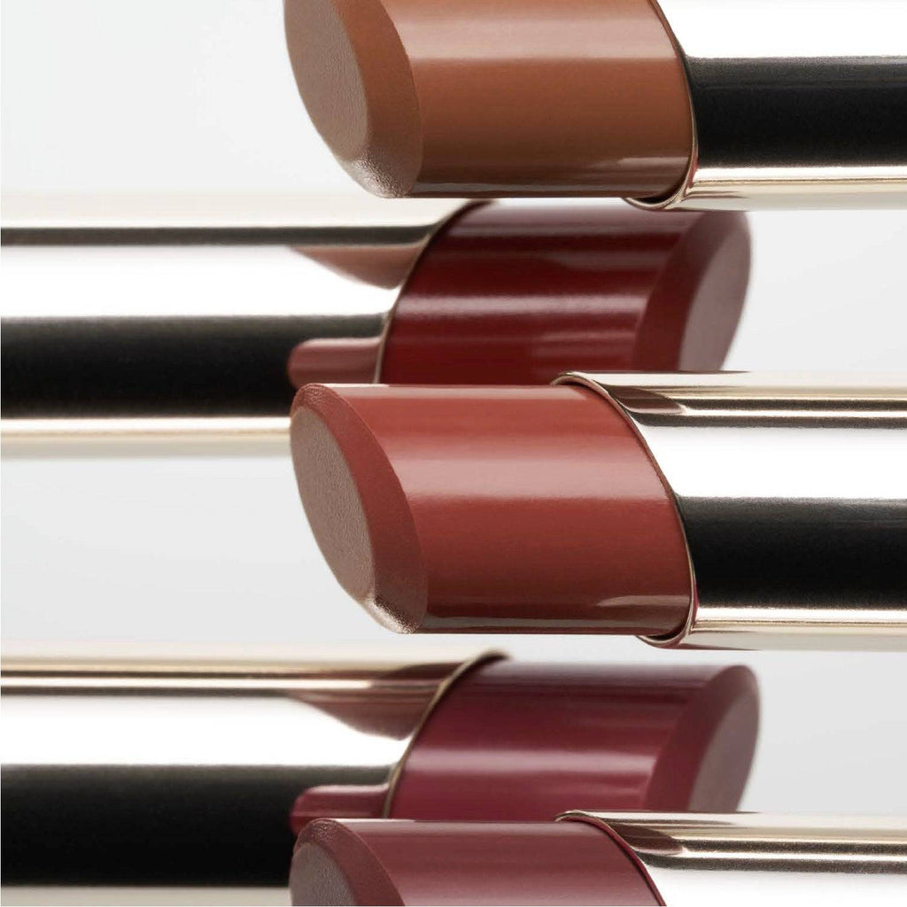 Close-up of RMK Dewy Melt Lip Color lipsticks in various shades, emphasizing their smooth, glossy textures and luxurious design.