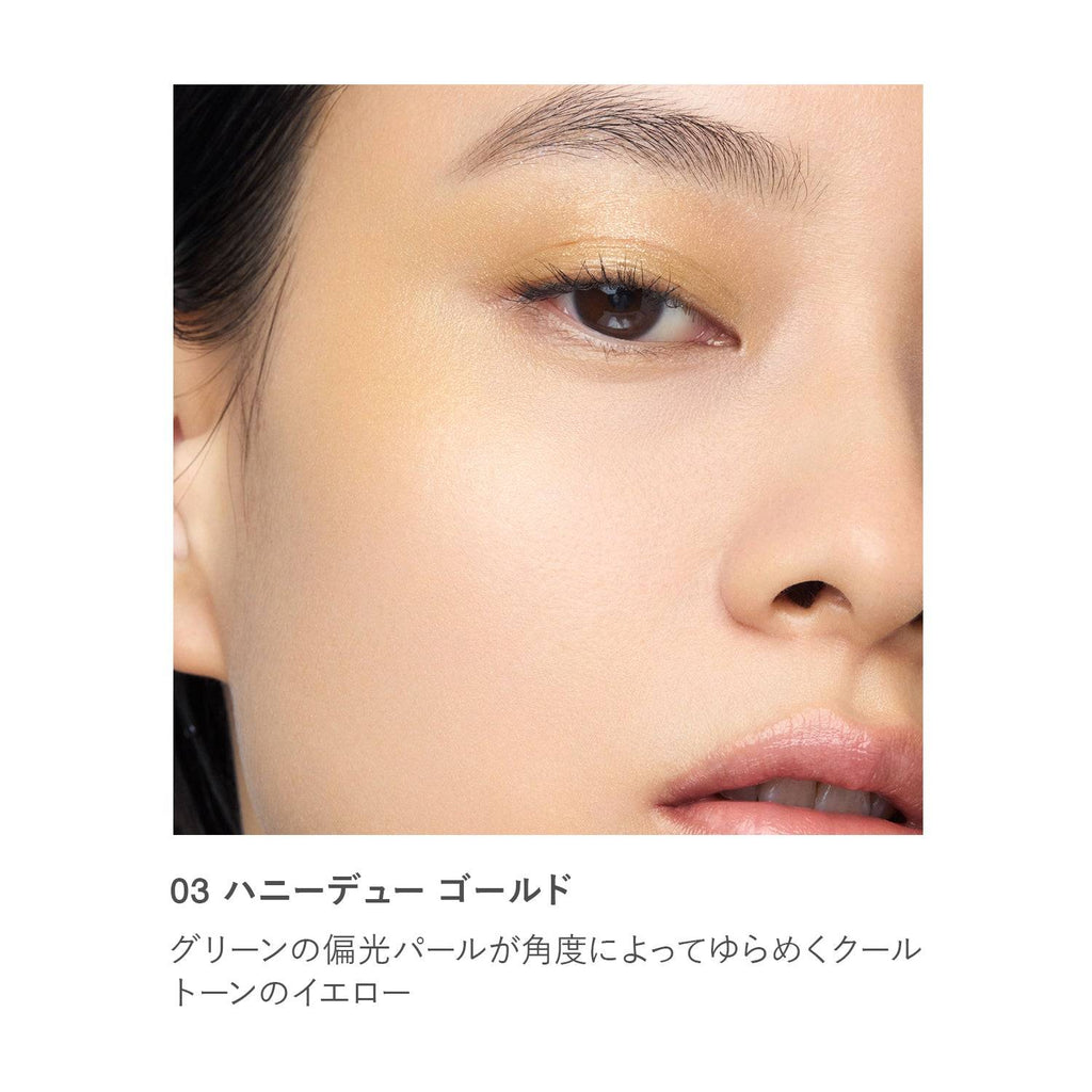 Close-up of RMK Radiant Color Stick 6.4g in shade 03 Honeydew Gold applied on skin, showcasing a luminous yellow glow.