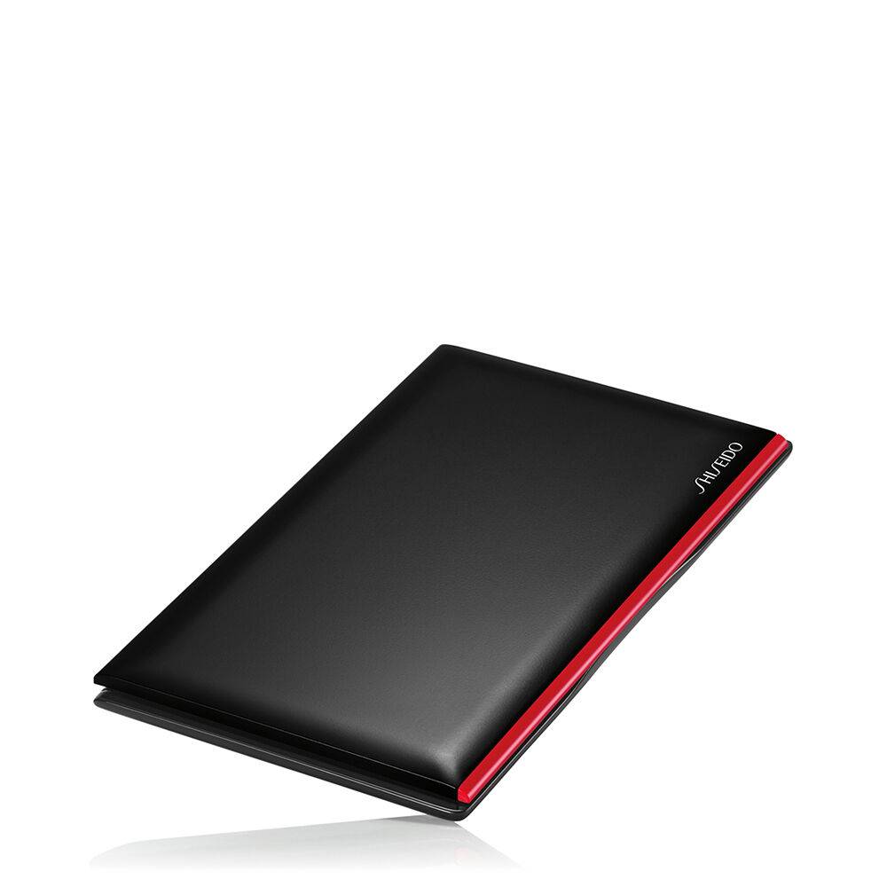 Closed Shiseido Synchro Skin compact case in black with a sleek red accent, designed for portability.