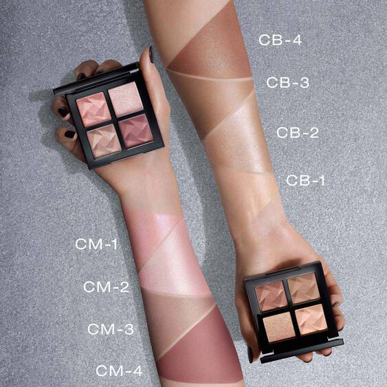 Swatches of Shu Uemura Eye Sculpt eye shadow shades on two arms, labeled CB-1 to CB-4 and CM-1 to CM-4, showcasing color variety.