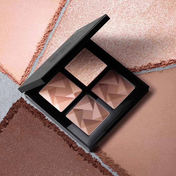 Shu Uemura Eye Sculpt palette displayed with its four neutral shades surrounded by matching powder textures.