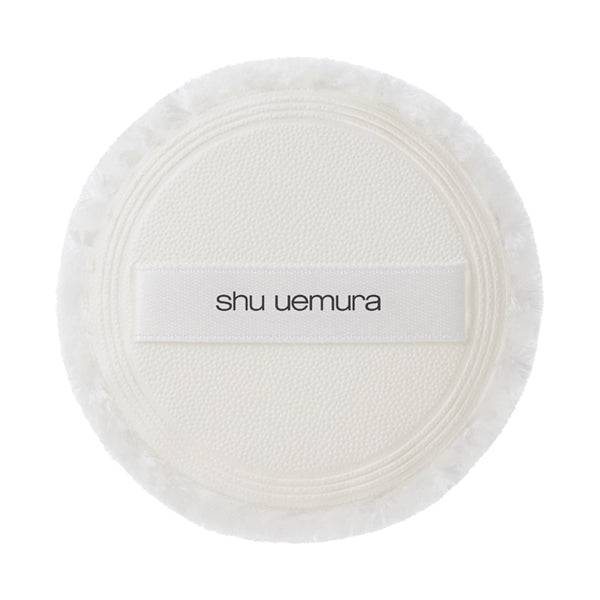 Close-up of Shu Uemura Unlimited Washi Veil Setting Powder puff with soft texture and branded strap for easy and even application.