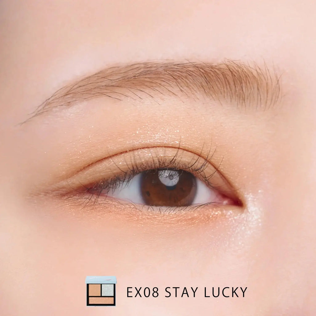 Close-up of an eye wearing Snidel Beauty EX08 Stay Lucky palette with a shimmering gold and silver eye makeup look.