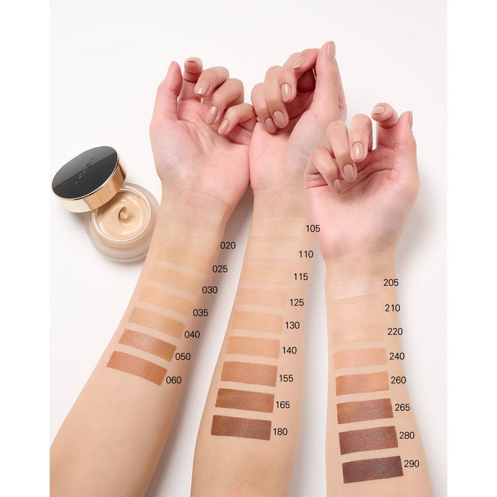Side profile of a model with Suqqu The Foundation 30g swatches in shades 110, 115, 210, and 020 applied on the cheek.
