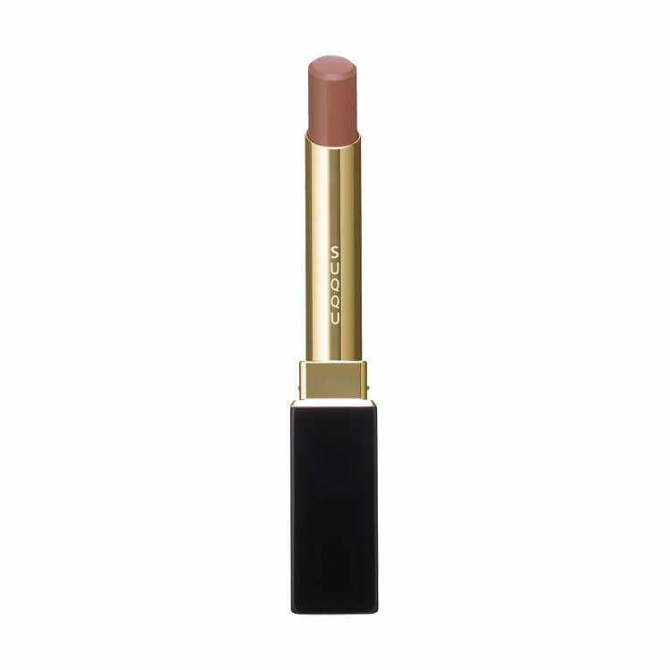 Suqqu Velvet Fit Lipstick in a soft brown shade, encased in an elegant black and gold tube, designed for a uniform color finish.