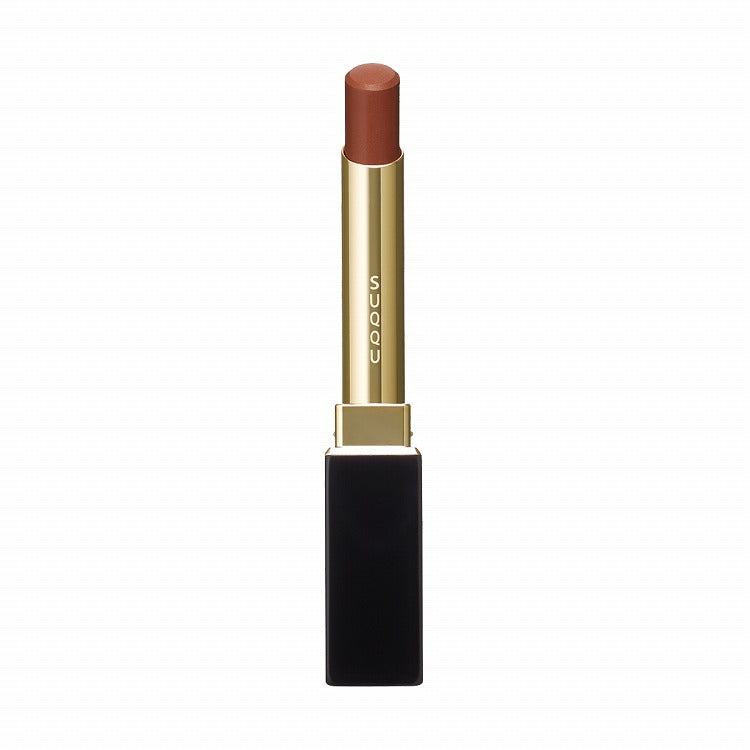 Suqqu Velvet Fit Lipstick in a deep terracotta shade, encased in a luxurious black and gold tube for a rich color payoff.