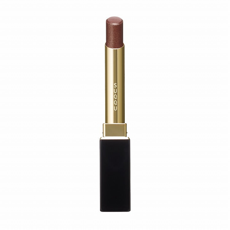 Suqqu Velvet Fit Lipstick in a glittery brown shade with a sleek black and gold tube, offering a creamy and luminous texture.