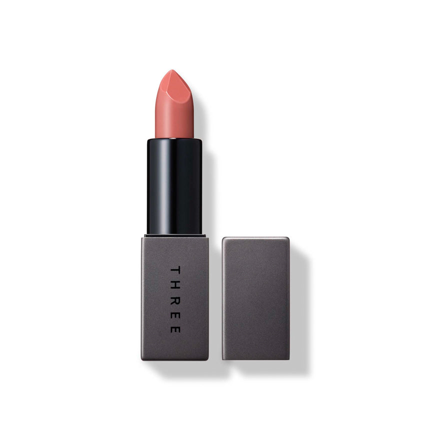 Three Dream On Alluring Lip Stick in shade 04 Cool Communicator, a muted coral tone with stylish gray packaging. Great for a natural look.