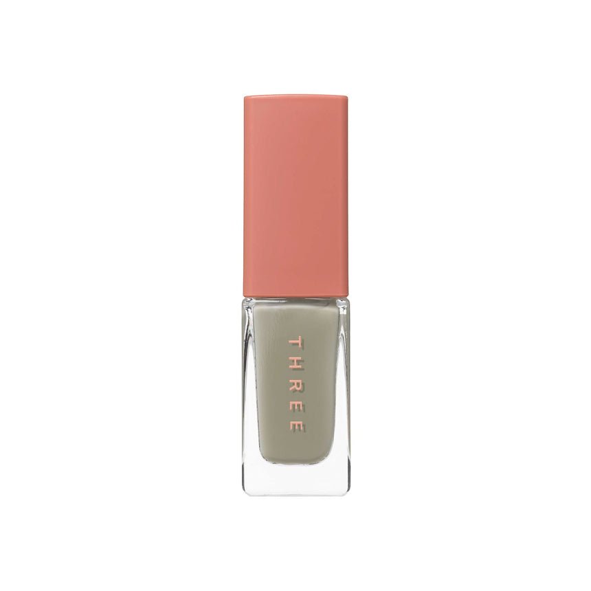 Three Nail Lacquer 7ml in muted gray-green shade with a peach-toned cap, perfect for subtle and modern nail designs.