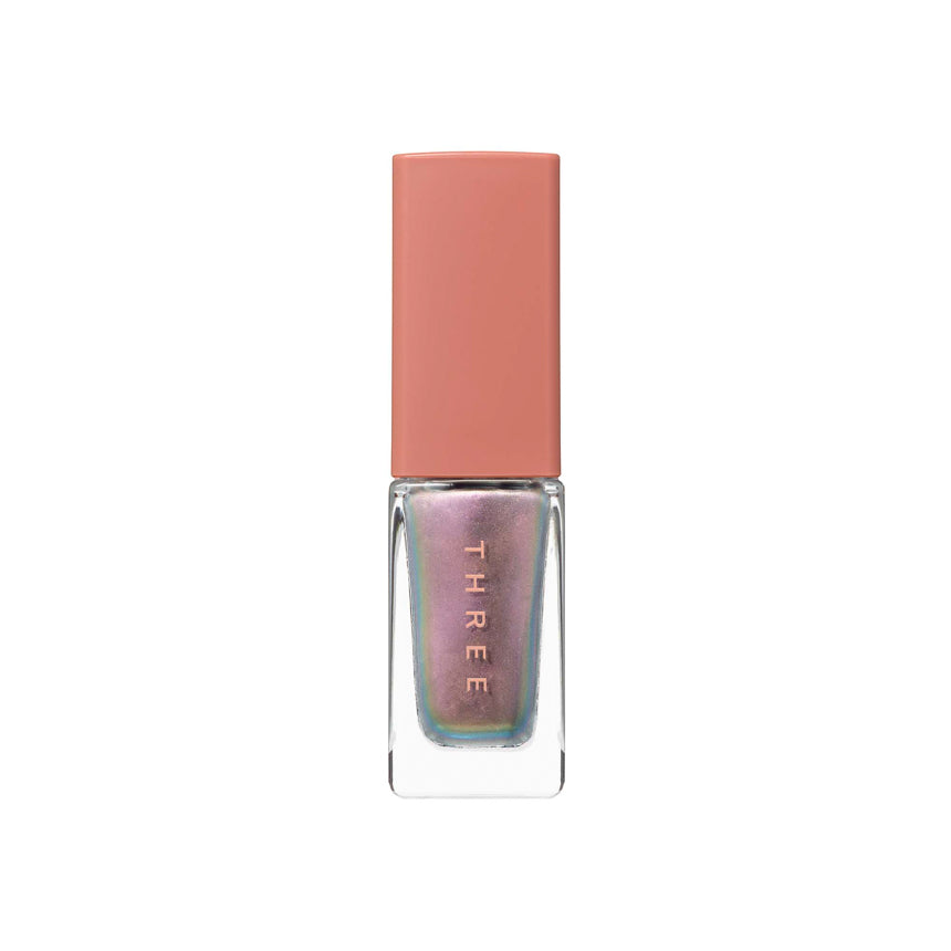 Three Nail Lacquer 7ml in iridescent multicolor shade with a peach-toned cap, ideal for unique and eye-catching nail looks.