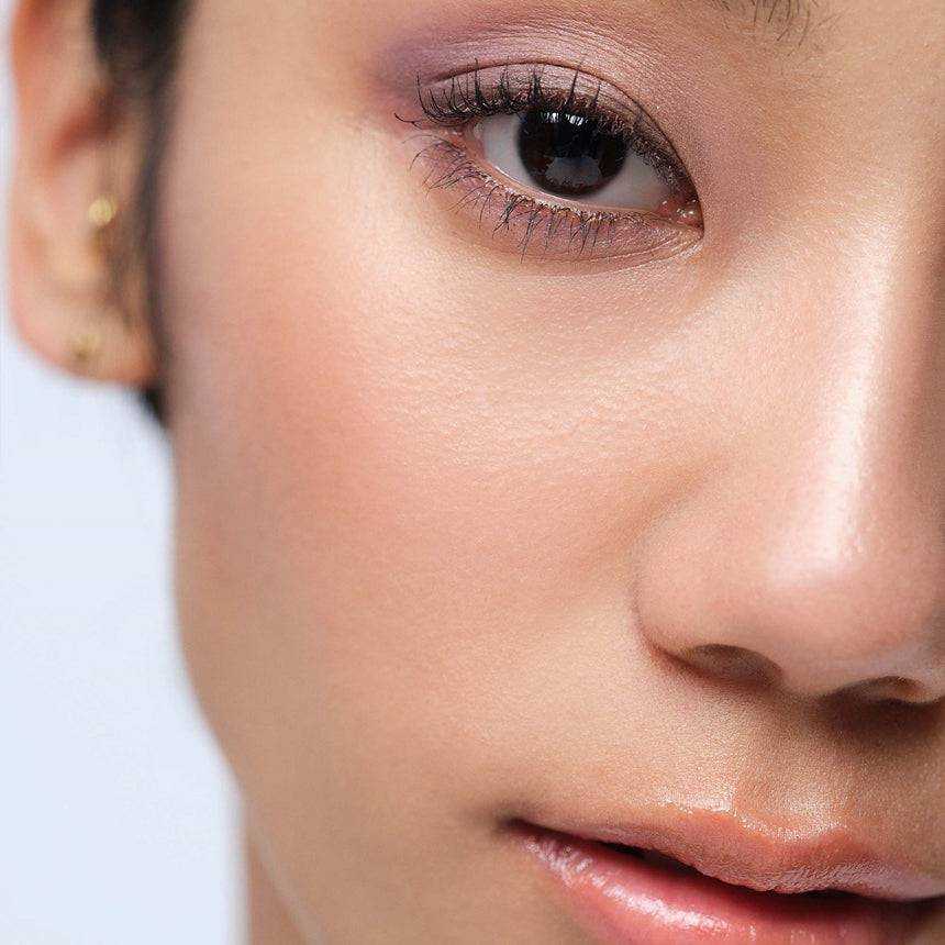 Model wearing Three Glam Tone Color Custard in a soft purple shade, showcasing its versatility for a natural and radiant look.