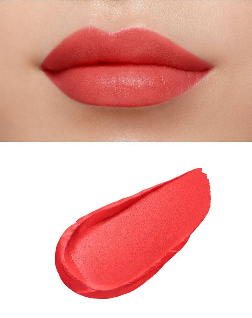 Clé de Peau Beauté Rouge Creme Matte 8g applied on lips, showcasing a vibrant matte coral finish for soft, supple lips.