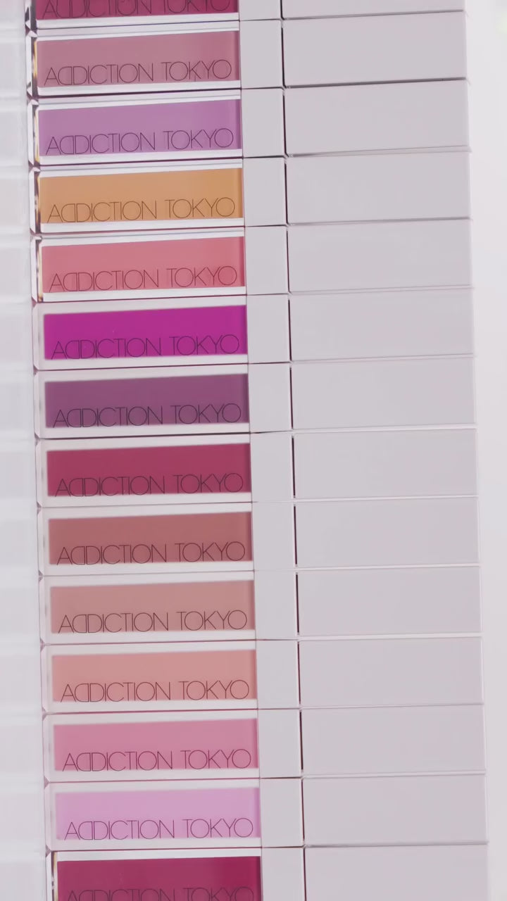 A collection of Addiction Tokyo The Liquid Blush Foggy in various shades, neatly stacked to showcase the diverse color range.