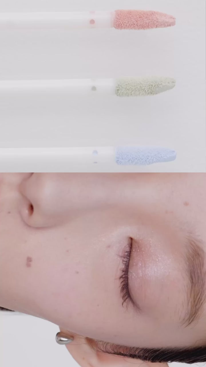 Close-up of Tokyo Color Corrector applicators in peach, mint, and blue shades. Demonstrates smooth application for a natural skin tone.